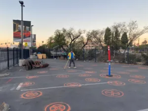 orange circles spray-painted on a parking lot mark core drilling locations