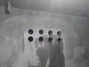 imt residential concrete coring with 8 core holes in wall