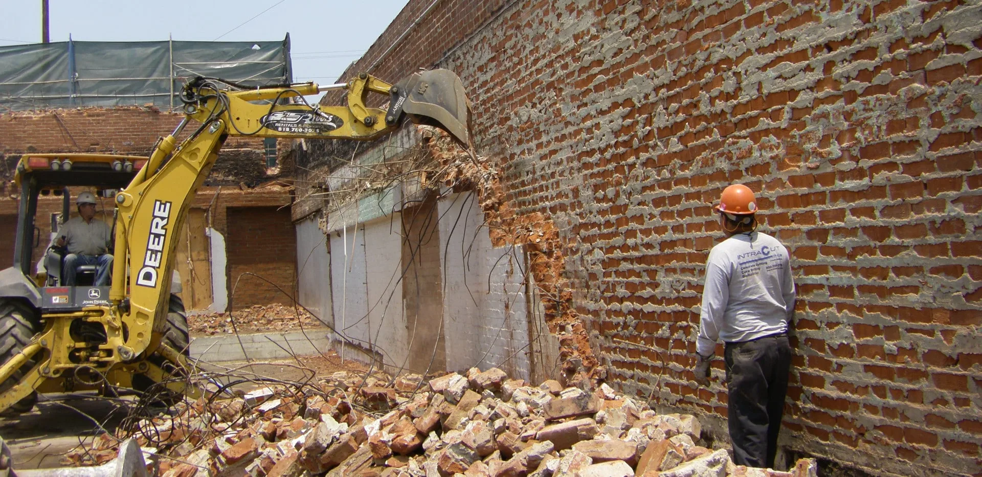 wall demolition project with excavator