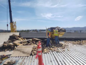 removing concrete debris from roof top at takeda pharmaceuticals construction site