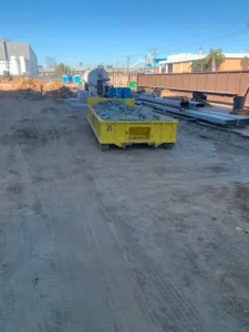 large dumpster bin full of demolition debris at northrop grumman