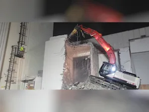 excavator demolishing a multi-story high-bay structure at northrop grumman