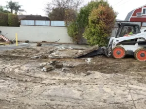 bobcat removing concrete slab at residential care facility in azusa, ca