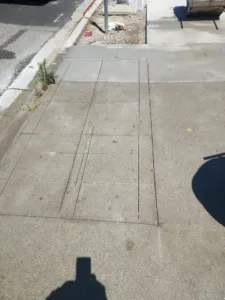 Outdoor concrete slab with parallel cuts from a flat sawing operation